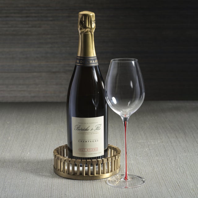 A luxurious combination of natural and metallic elements, this round wine bottle coaster features a matte gold-tone...