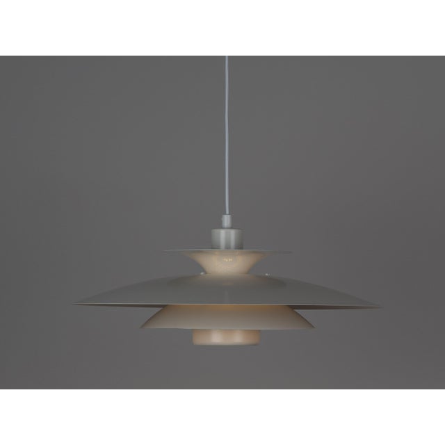 This distinctive pendant lamp was designed by Danish designer **Kurt Wiborg** and manufactured by **Jeka**. The design is...