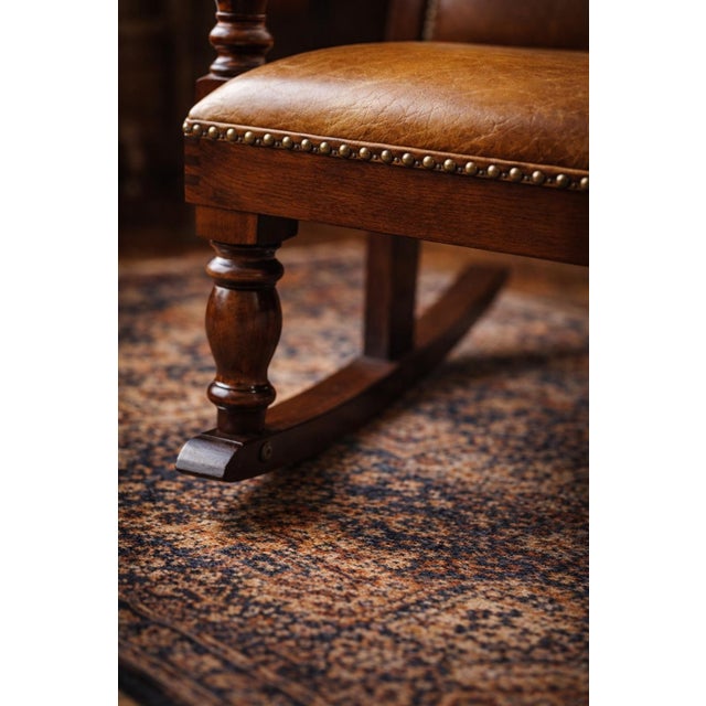 This antique American rocking chair features a beautifully proportioned wooden frame with classic turned legs, shaped...