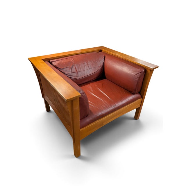 Wonderful vintage mission style armchair. Red leather cushions. Some wear on the corners of the wood. Overall nice shape.
