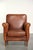 This sturdy vintage sheepskin armchair features a beautiful cognac color and a comfortable seat. The armchair is a stylish...
