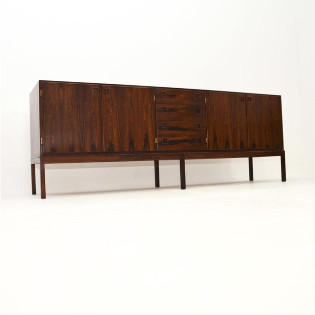 A stunning and rare Danish vintage sideboard by Johannes Andersen for Bernhard Pedersen. This was made in Denmark, it...