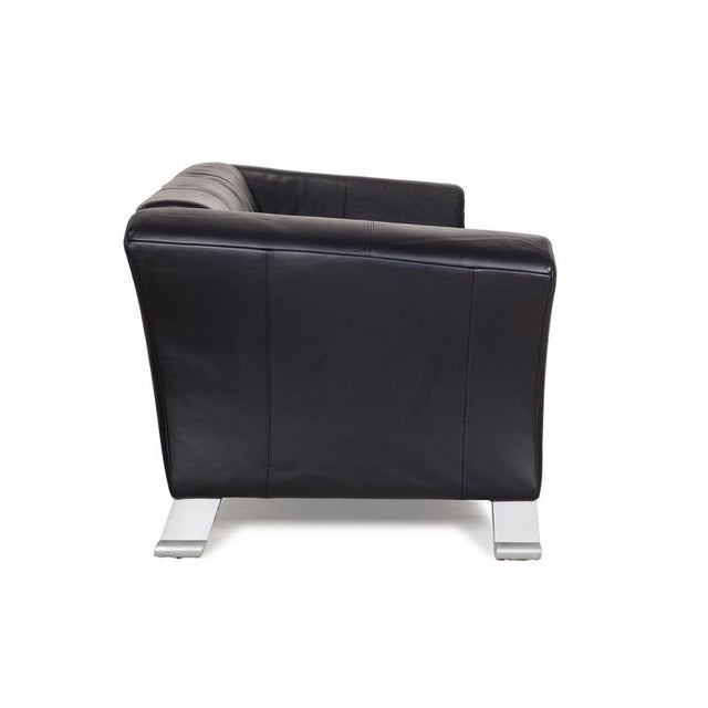 The 322 sofa by Rolf Benz is covered in black-blue leather and stands on silver metal feet. The modern design and the...