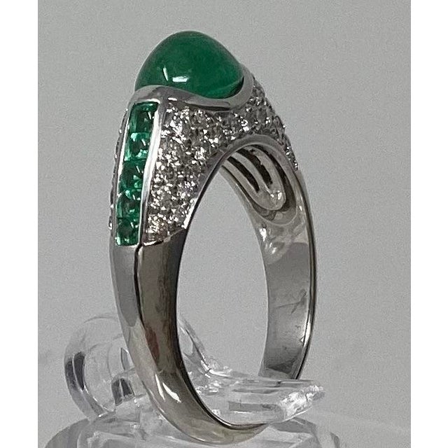 Emerald 1.5ct w medium dark kelly green hue at the center. There are 10 square shaped cabochon cut 2x2 mm genuine emeralds...