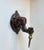 A pair of elephant candle sconces in cast bronze. Regency style with a hint of colonial fauna. Each elephant head has a...