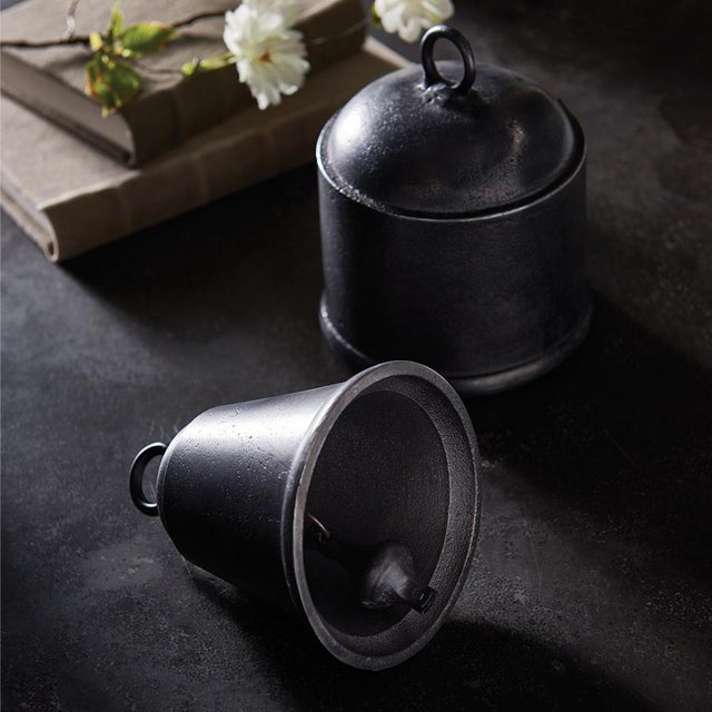 Old fashioned objets in cast aluminum, these historic shapes are functioning bells. Place atop a stack of art books on the...