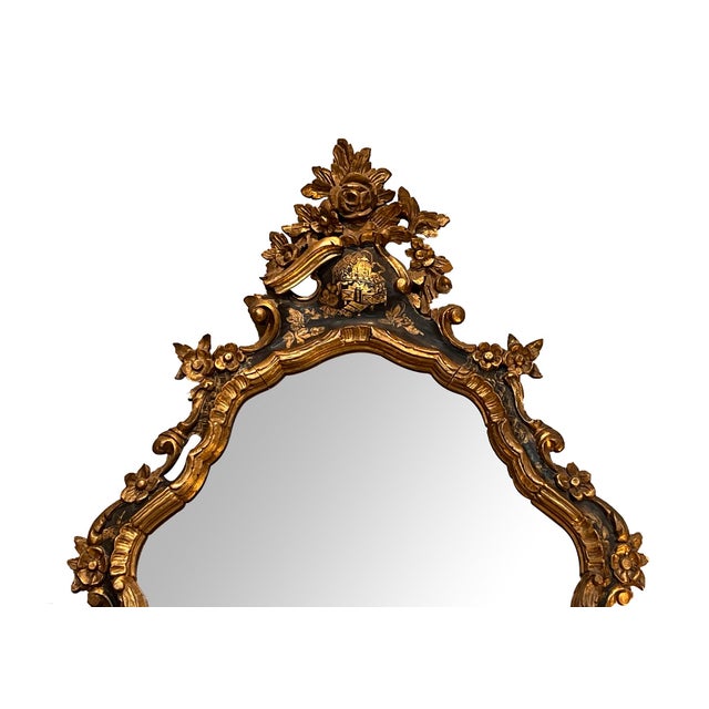 the shapely arching crest surmounted by a floral cluster emanating floral and foliate vines cascading around the perimeter...