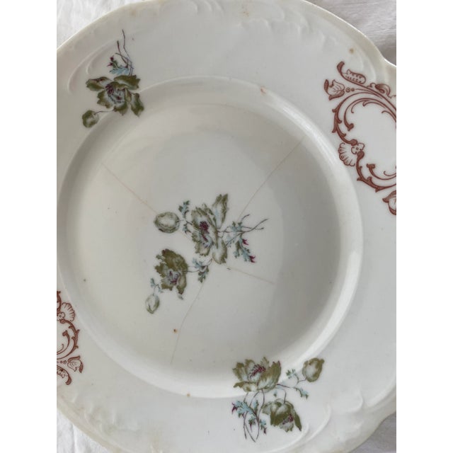 Pr of antique decorative plates in grew. And sepia on white. Great to be used as wall decor.