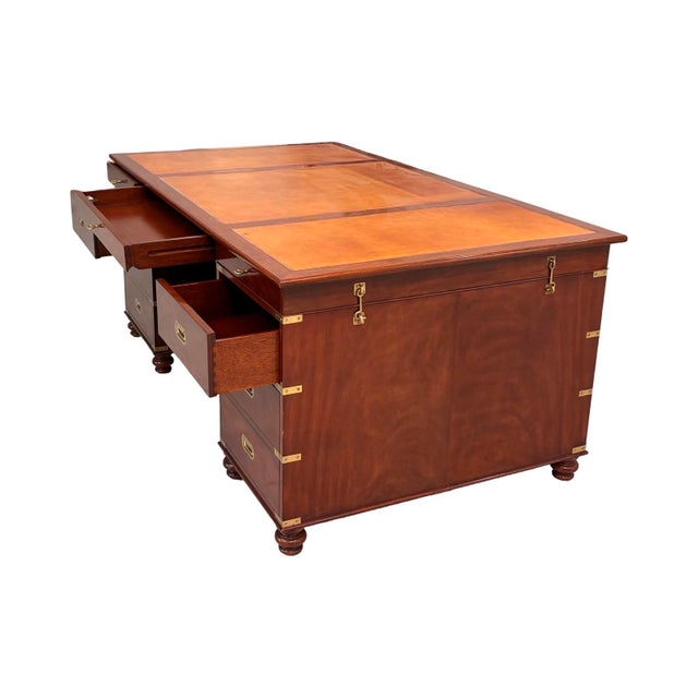 This piece is an authentic Ralph Lauren Home mahogany partners desk featuring military-influenced campaign styling....