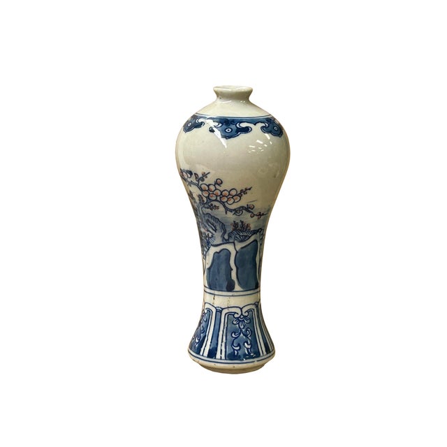 This elegant blue and white porcelain vase features a classic meiping-inspired silhouette, characterized by its high,...