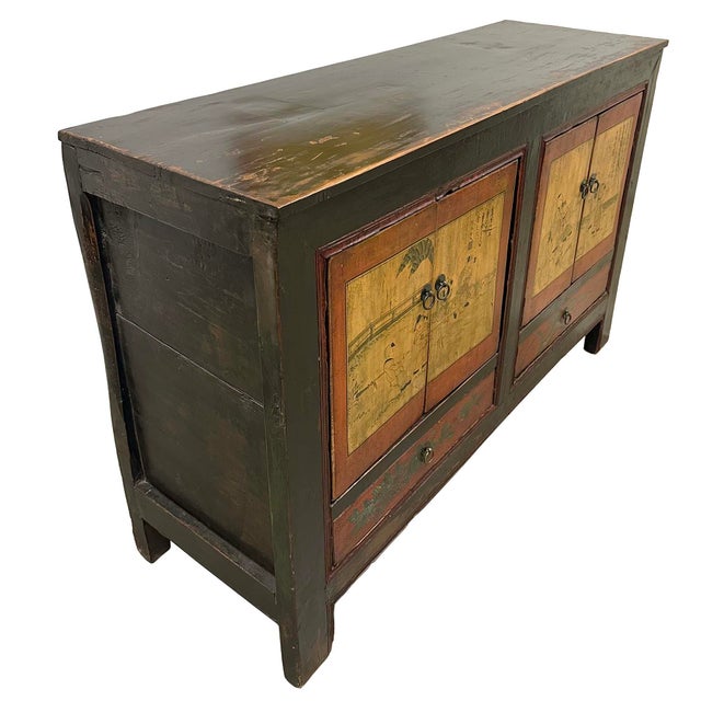 This piece is an antique Chinese painted lacquer cabinet, often categorized as a sideboard, coffer, or Credenza. It has...