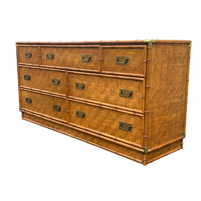 A beautiful 7 drawer low dresser. In the campaign style made by Dixie furniture. Super mixed element design having finely...