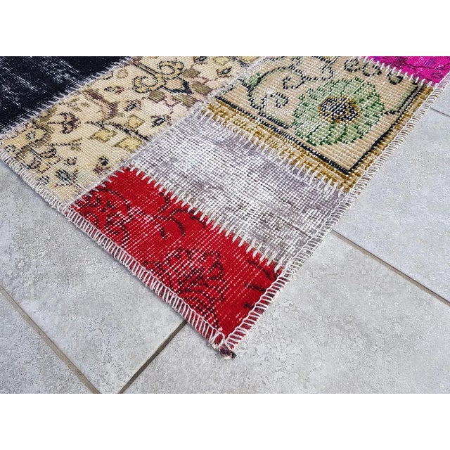 This is a vintage Turkish Oushak rug from the Mid 20th Century. The piece was hand-knotted.