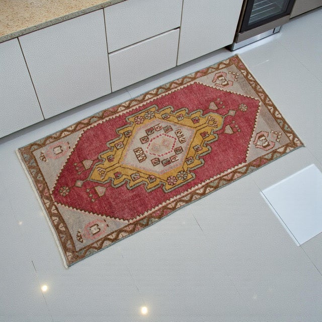 This exquisite hand-knotted small rug features a vibrant stepped medallion design set against a beautifully aged...