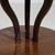 Round pedestal center table in Rich Mahogany. Its rich mahogany finish sets off scrolled tripod base, glass-topped...
