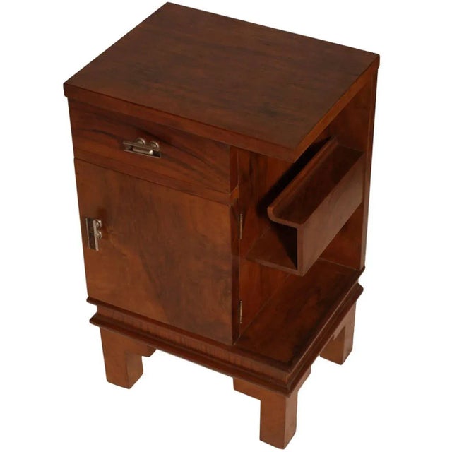 This sculptural Art Deco nightstand was designed by Osvaldo Borsani. It is made from walnut and burl walnut and features...