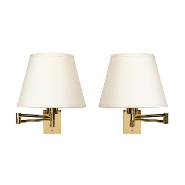This brilliant pair of Mid-Century Modernist Articulating Wall Sconces in Polished Brass by George W. Hansen for Metalarte...