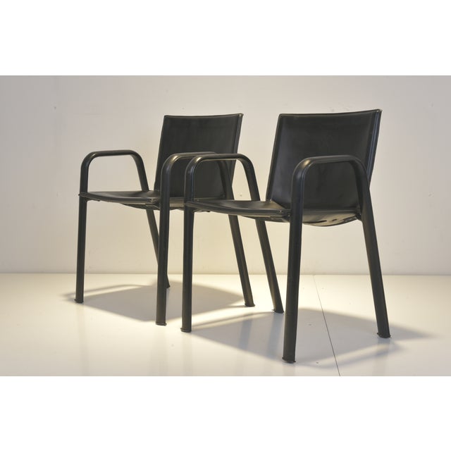 Two armchairs with leather upholstery, signed Poltrona Frau An elegant pair of armchairs from Poltrona Frau, crafted from...