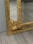 Important antique wall mirror in finely crafted and gilded metal. The richly openwork pediment features scrolls, foliage,...