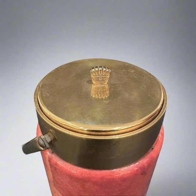 Aldo Tura Modernist ice bucket. Salmon colored parchment with brass plated details. Additional dimension of the body with...