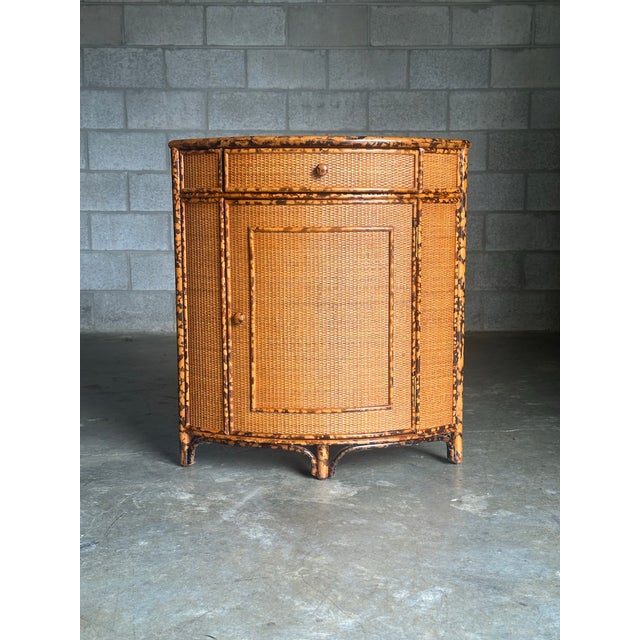 Unusual British colonial style bamboo and rattan corner cabinet attributed to Ralph Lauren for Bloomingdale’s. Great size...