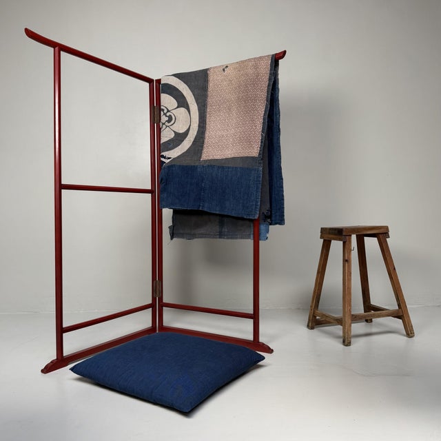 This Japanese kimono hanger (ikō) is an elegant, folding textile display with a slender form and a quietly understated...