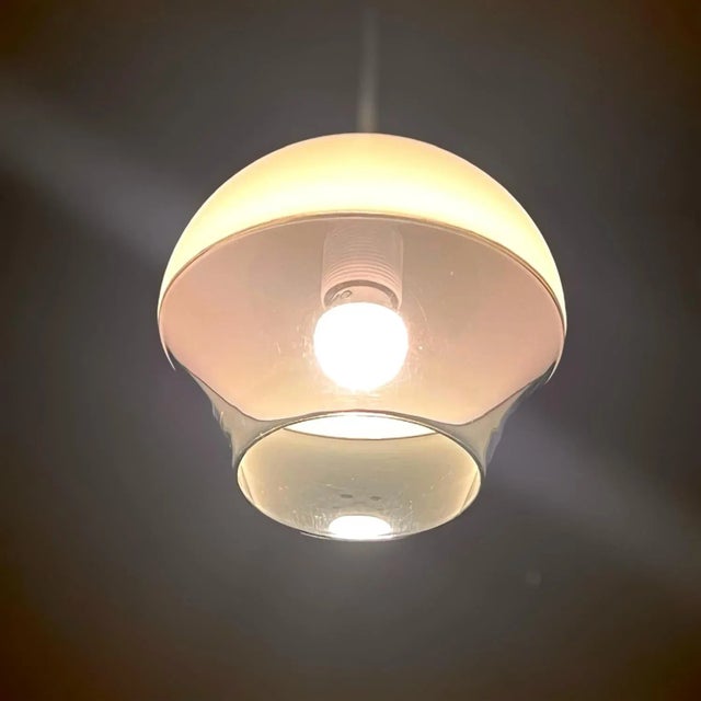 Discover the allure of the Space Age with this stunning UFO lamp, crafted in Italy during the 1970s. The lamp features a...