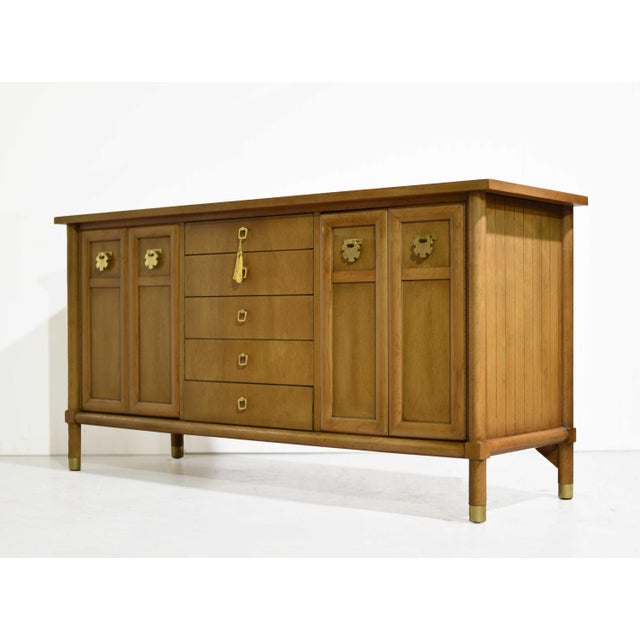 A refined blend of mid century simplicity and Asian-inspired detailing, this buffet by American of Martinsville brings...