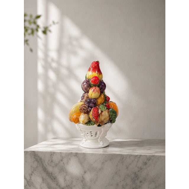 A refined vintage Italian majolica centerpiece depicting a vibrant, hand-painted pyramid arrangement of assorted...
