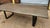 Large single-slab guanacaste wood dining table with a striking natural grain pattern and substantial organic-modern...