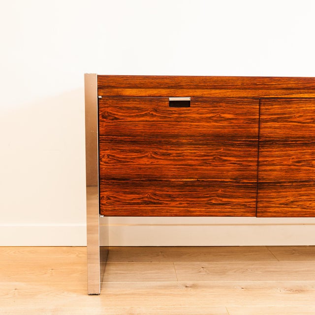 Sublimely seventies mid century modern rosewood credenza with chrome accents in beautifully refinished condition. Designed...