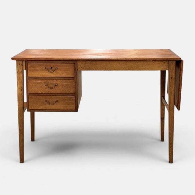 Extendable writing desk produced by a danish cabinet maker during the 1950s. executed with teak top and oak frame...