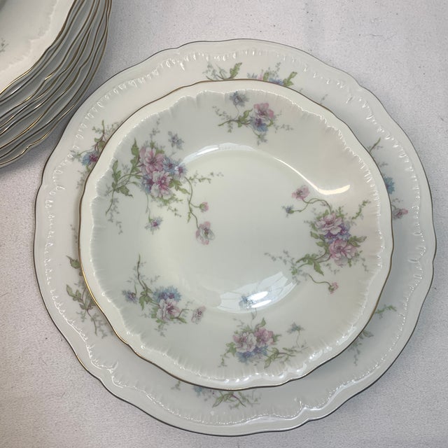 This stack of vintage fine china bowls and dinner plates features the Annette floral pattern by Haviland, accented with...
