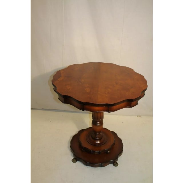 Great Regency style side end table made of fruitwood featuring a shaped top with match book veneer on top of a reeded...
