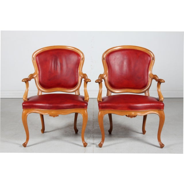 Pair of Danish Rococo armchairs of walnut upholstered with reddish aniline leather with patina. Handcrafted and carved by...