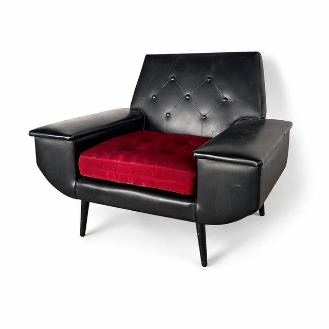 A bold and characterful mid-century armchair featuring classic proportions and strong sculptural form. Upholstered in...