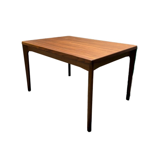 Wonderful vintage Danish draw leaf mid century modern dining table made out of teak wood. The table is constructed with a...