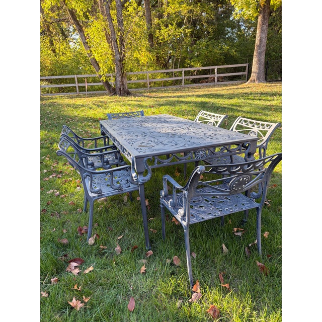 An elegant vintage seven-piece garden dining set attributed to Florentine Craftsmen, featuring the iconic Star & Dolphin...