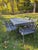 An elegant vintage seven-piece garden dining set attributed to Florentine Craftsmen, featuring the iconic Star & Dolphin...