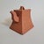 A sculptural Chinese Yixing clay teapot dating to the 1970s-80s, distinguished by its sharply tapered rectangular form,...