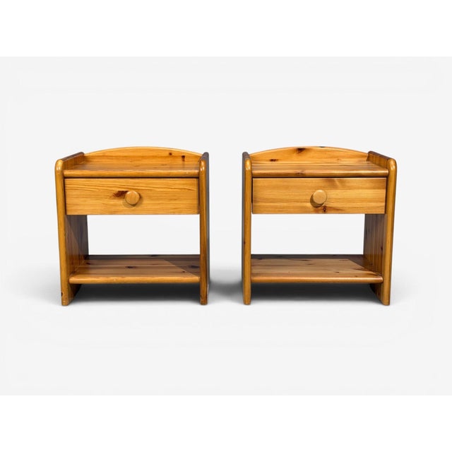 Swedish Mid-Century Modern, Nightstands or Bedside Tables, Pine, Sweden, 1960s A pair of modernist pine nightstands...