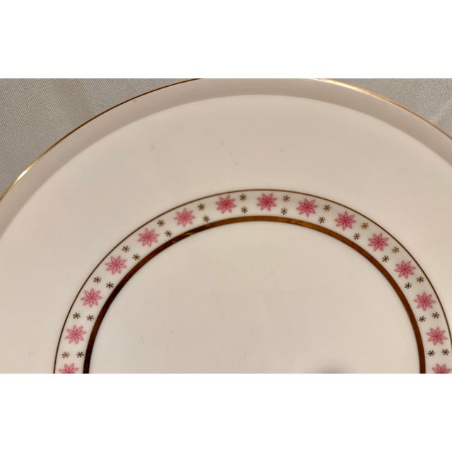 A Mid-Century Pink Atomic Star place setting consisting of 6 pieces. White background accented with a light grey rim with...