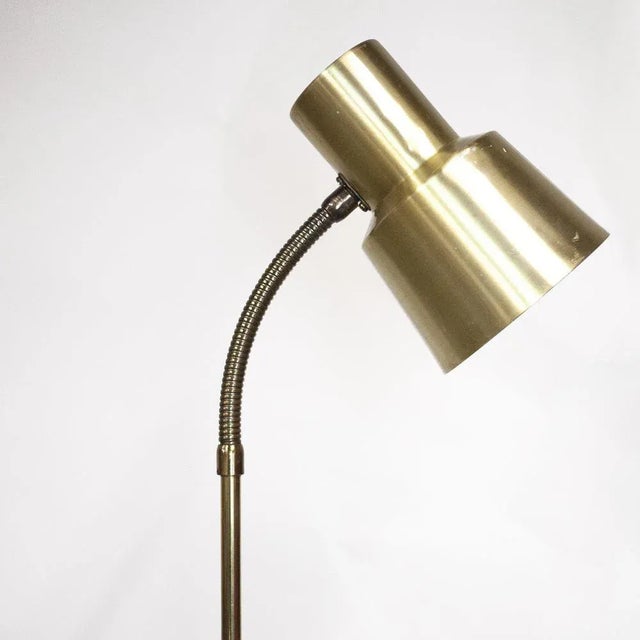 This vintage floor lamp features an adjustable gooseneck. This piece is attributed to the mentioned designer/maker. It has...