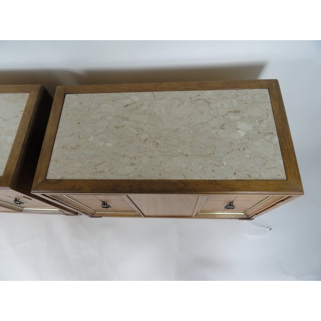 Pair of side tables made of fruitwood with an inlaid marble top. Metal painted accent on doors with original hardward....