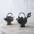 A pair of Chinese pewter koi-form teapots, 19th Century. larger: 9 ¾ inches wide by 4 inches deep by 9 ¼ inches tall...