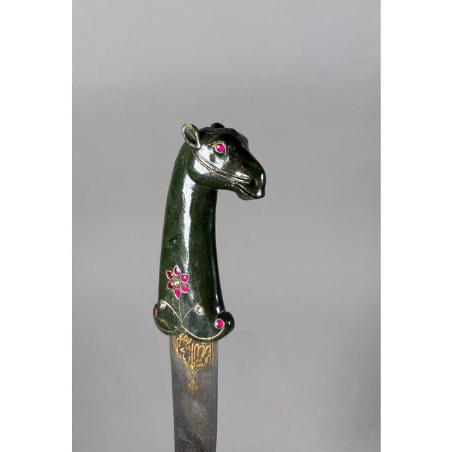 INDIA, Rajasthan. KARD Mughal Dynasty (1526-1857) The hilt is carved in spinach-green jade with a horse's head adorned...