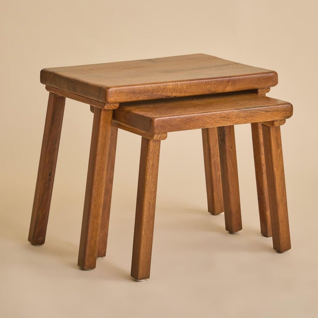 A pair of Dutch Brutalist oak nesting tables dating to the 1960s. Designed to nest seamlessly, each table features a...