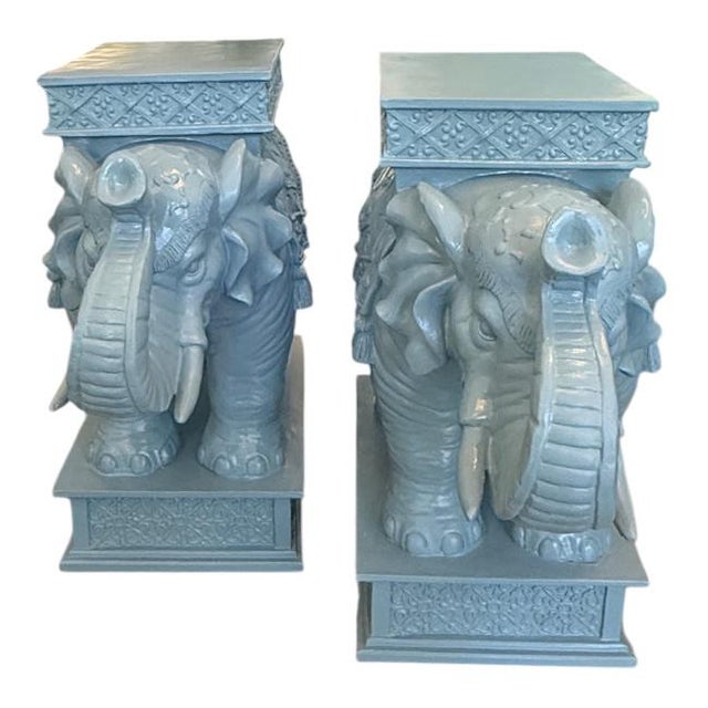 A pair of vintage Hollywood Regency elephant pedestal side tables. Expertly crafted with remarkable detail, each table...