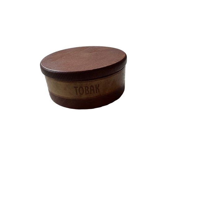 A charming Scandinavian mid-century “TOBAK” tobacco jar, hand-turned from solid hardwood and accented with a wrapped...