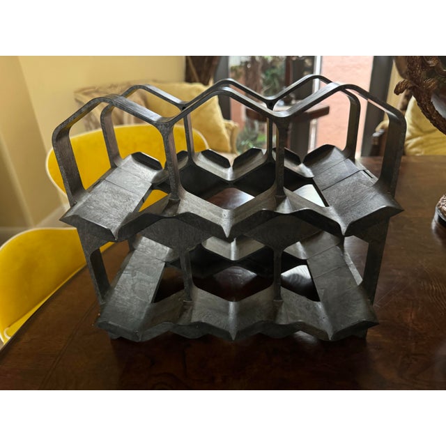 This vintage wine rack is a stunning piece of mid-century modern design, originating from Switzerland in the 1960s....